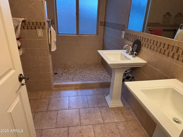 a bathroom with a sink a mirror and shower