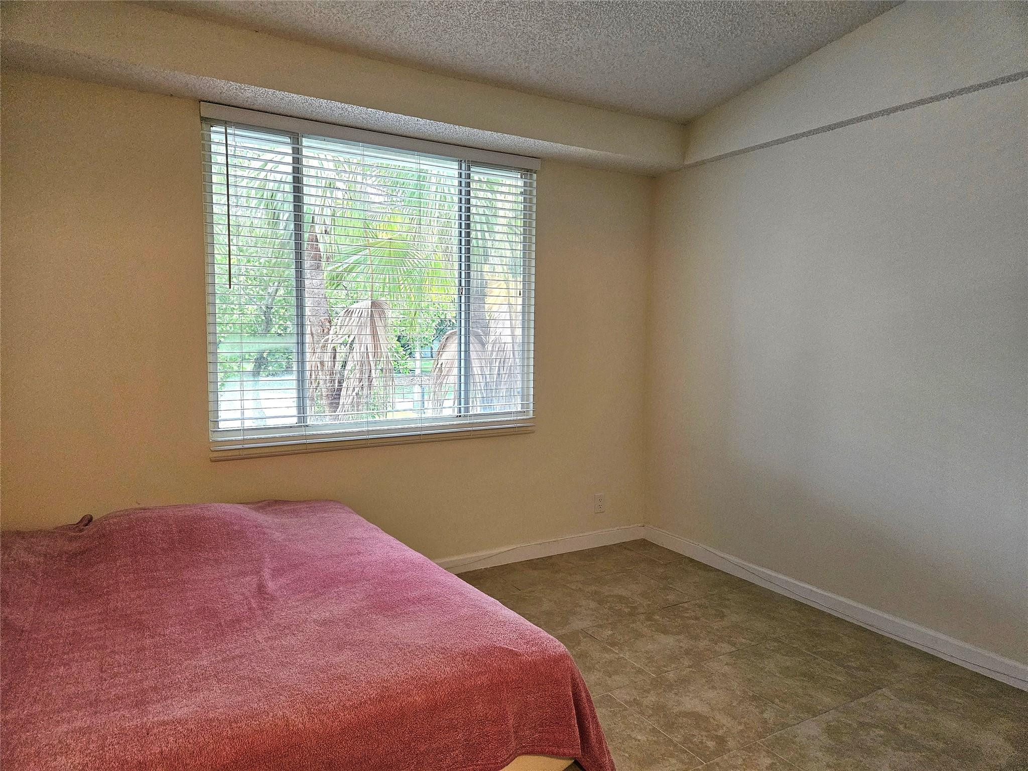 701 Lyons Road, Unit 13205 Coconut Creek, FL 33063 - Photo 16 of 37 an empty room with a window