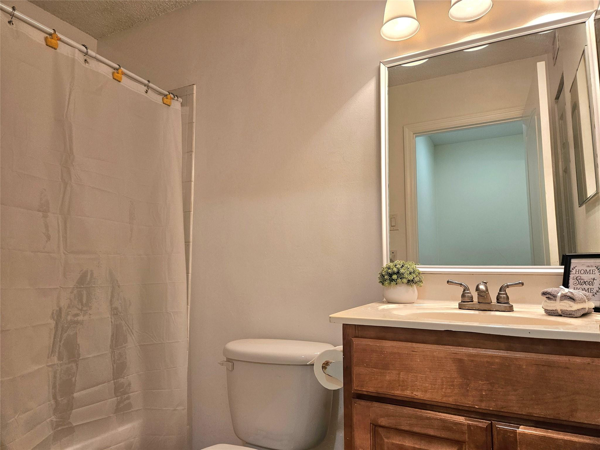 701 Lyons Road, Unit 13205 Coconut Creek, FL 33063 - Photo 17 of 37 a bathroom with a sink a toilet and shower