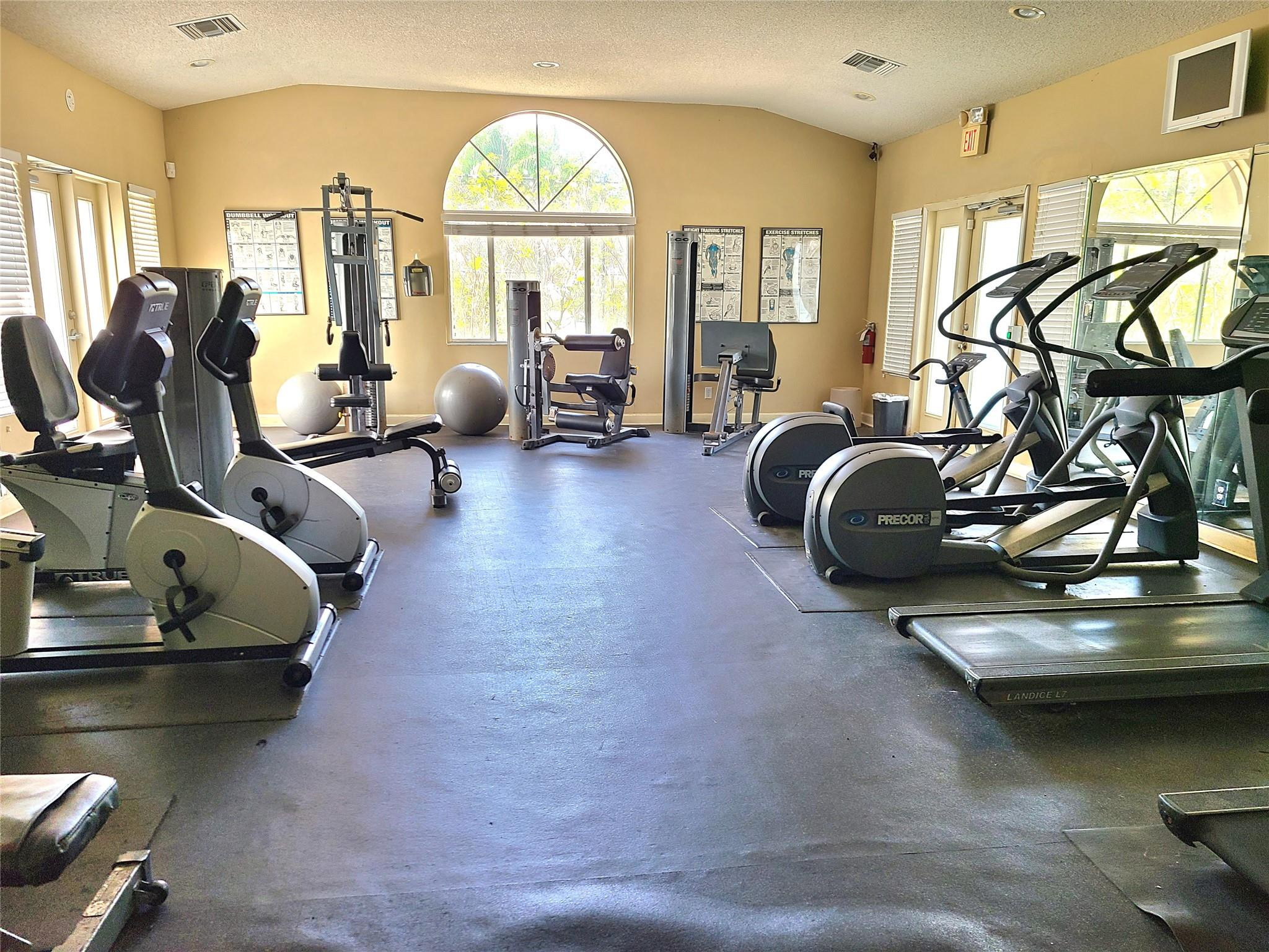 701 Lyons Road, Unit 13205 Coconut Creek, FL 33063 - Photo 27 of 37 a view of a room with gym equipment
