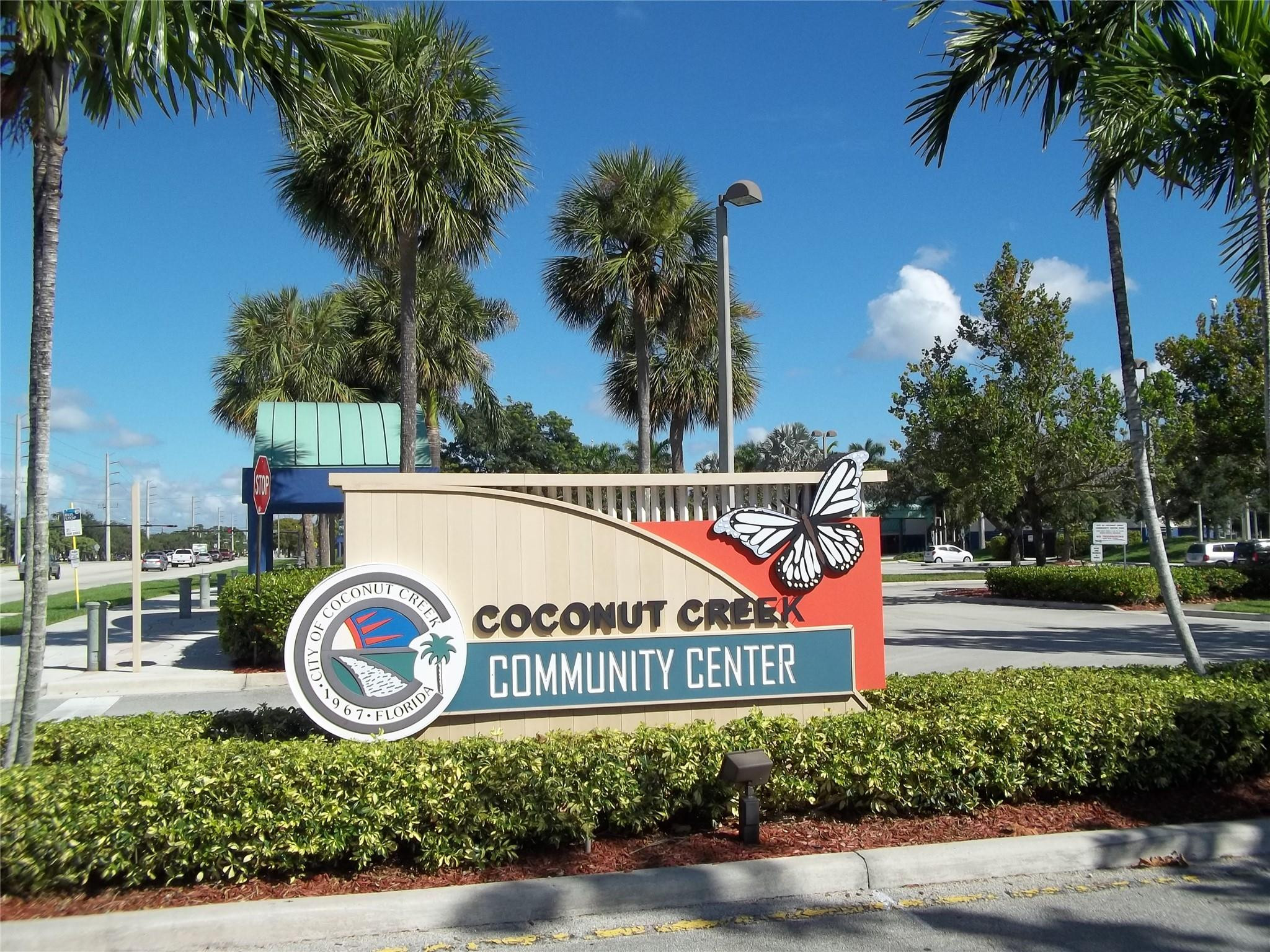 701 Lyons Road, Unit 13205 Coconut Creek, FL 33063 - Photo 34 of 37 a sign that is on the side of the road