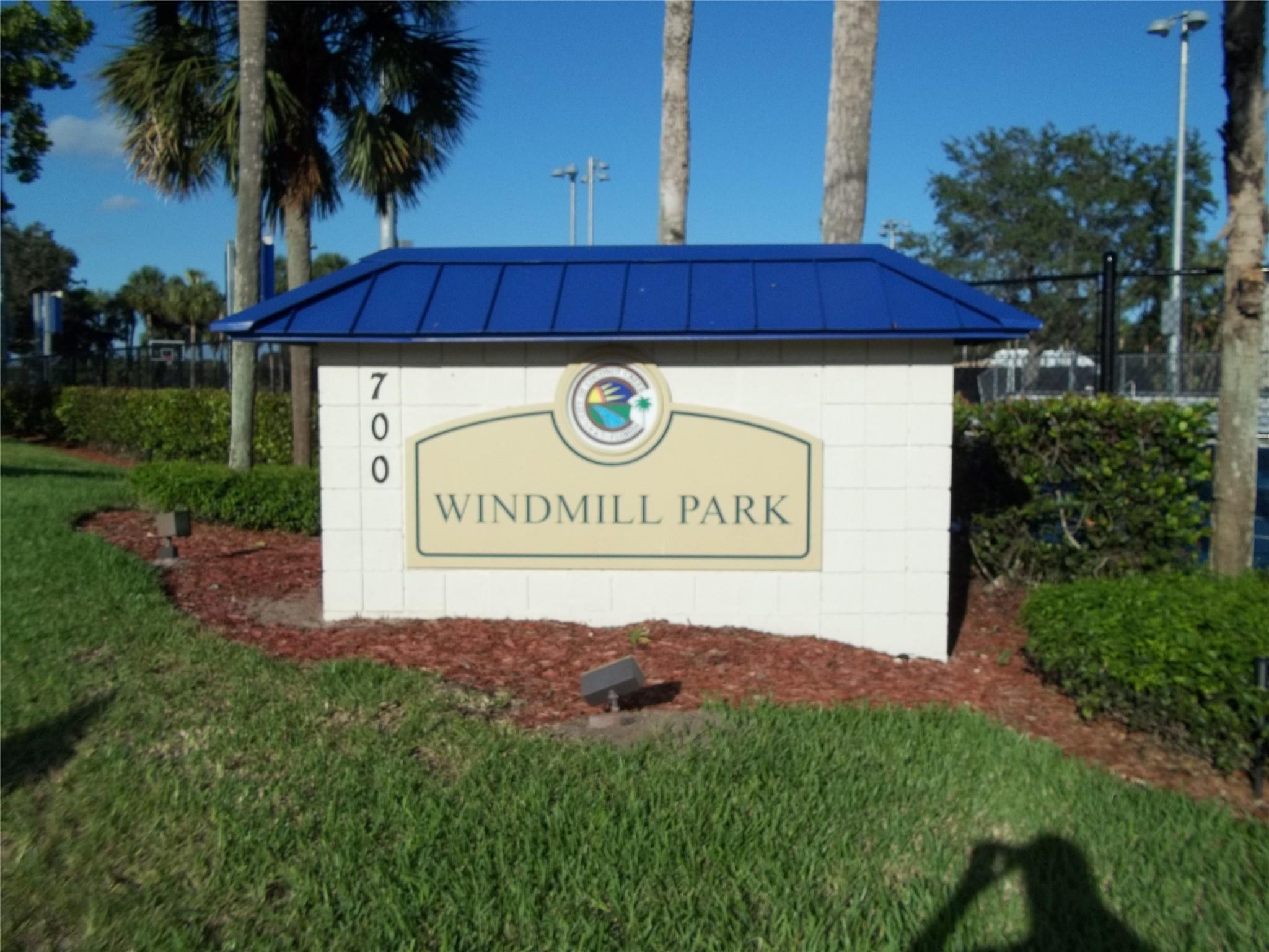 701 Lyons Road, Unit 13205 Coconut Creek, FL 33063 - Photo 35 of 37 a view of outdoor space with signage and flags