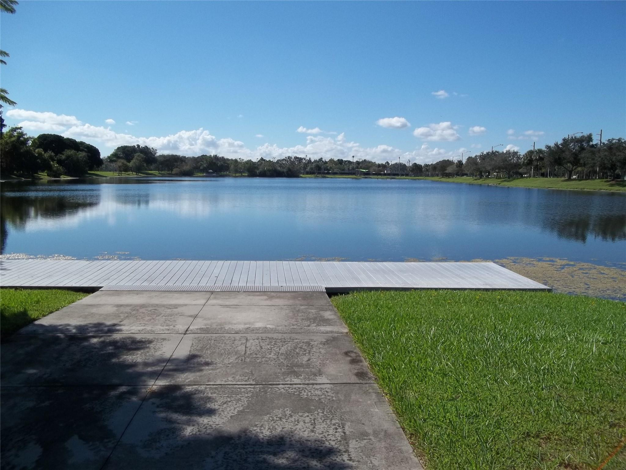 701 Lyons Road, Unit 13205 Coconut Creek, FL 33063 - Photo 36 of 37 a view of a lake with houses