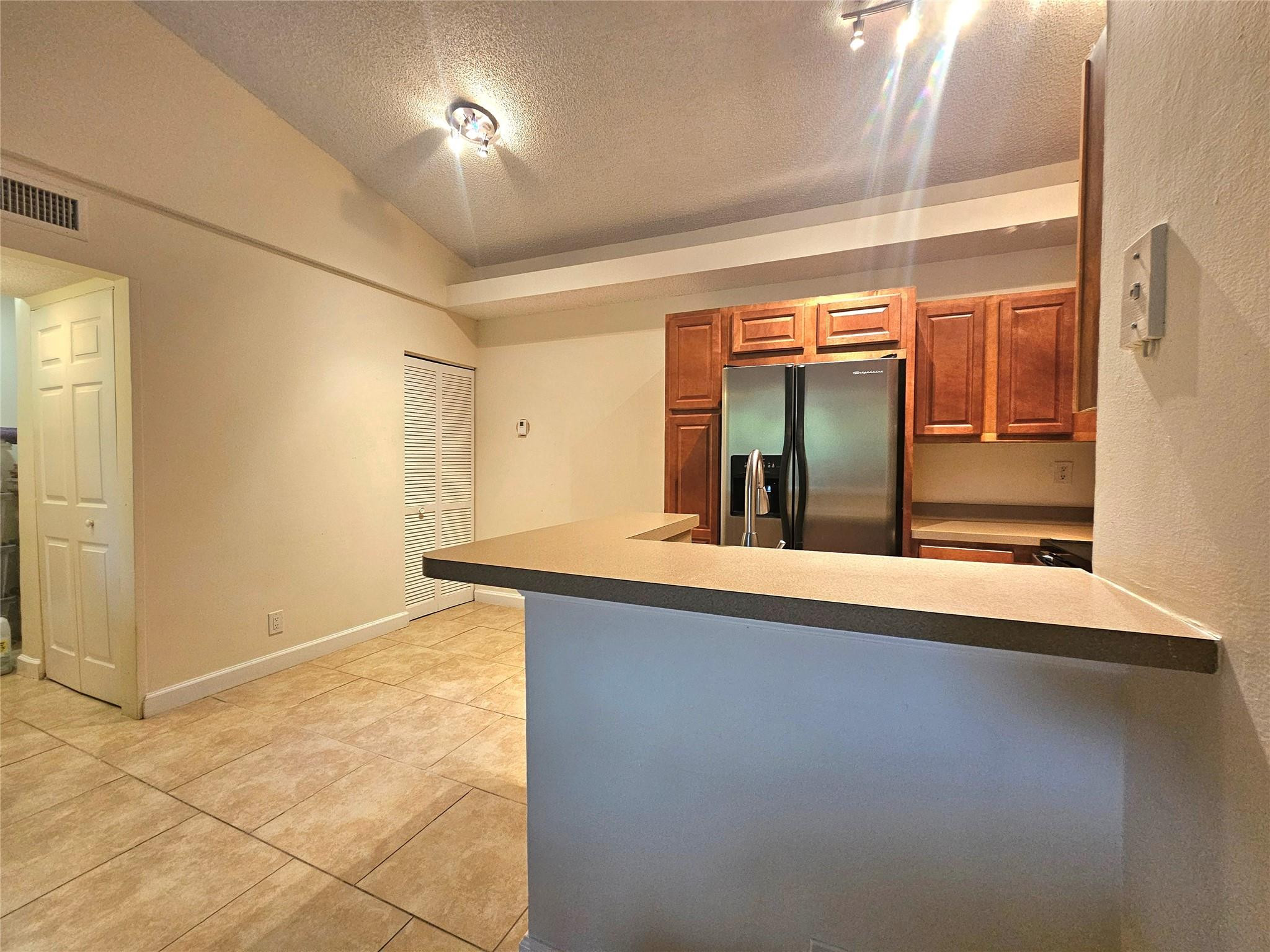 701 Lyons Road, Unit 13205 Coconut Creek, FL 33063 - Photo 7 of 37 a view of an empty room with window