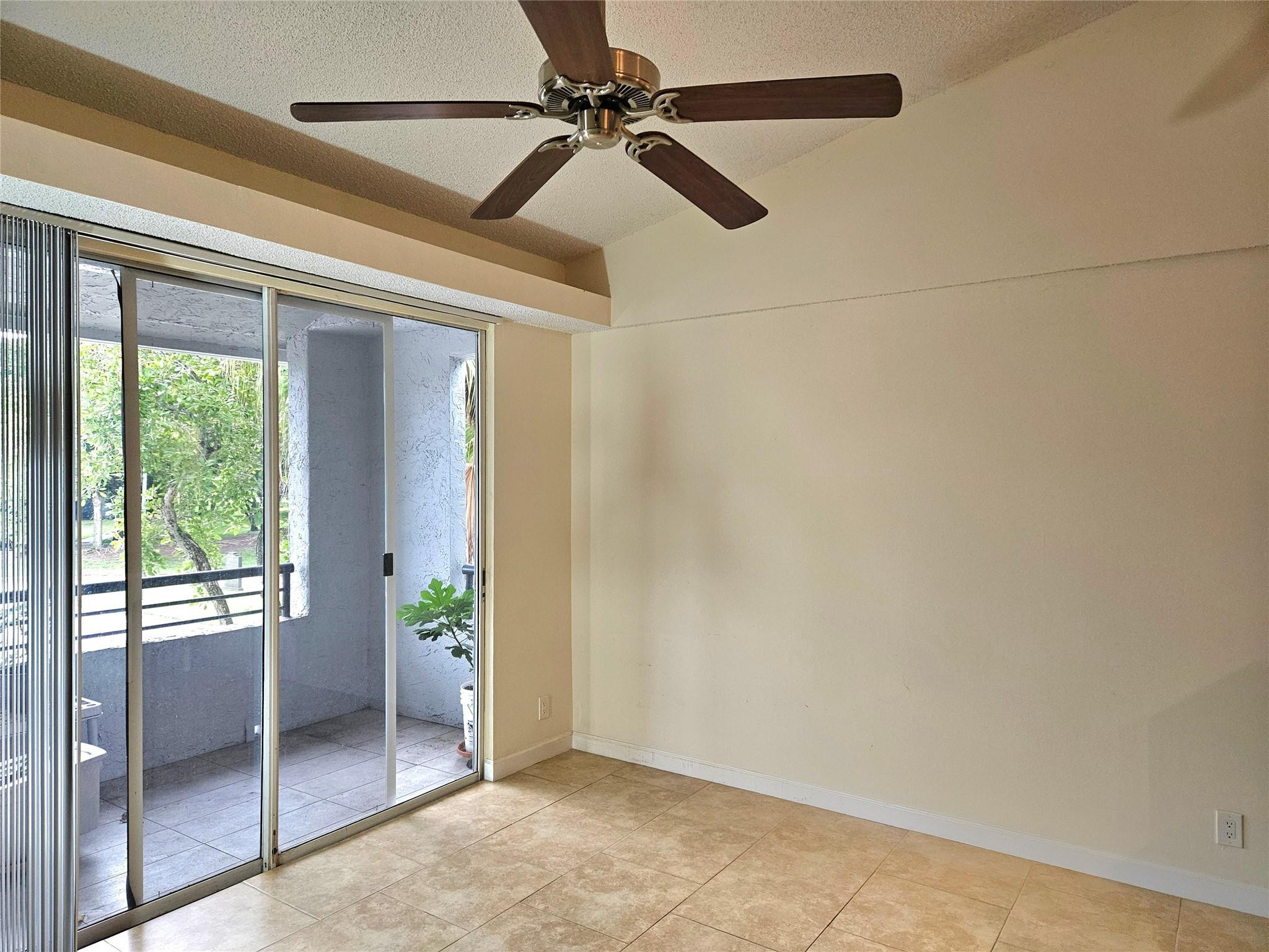 701 Lyons Road, Unit 13205 Coconut Creek, FL 33063 - Photo 9 of 37 a view of an empty room and window