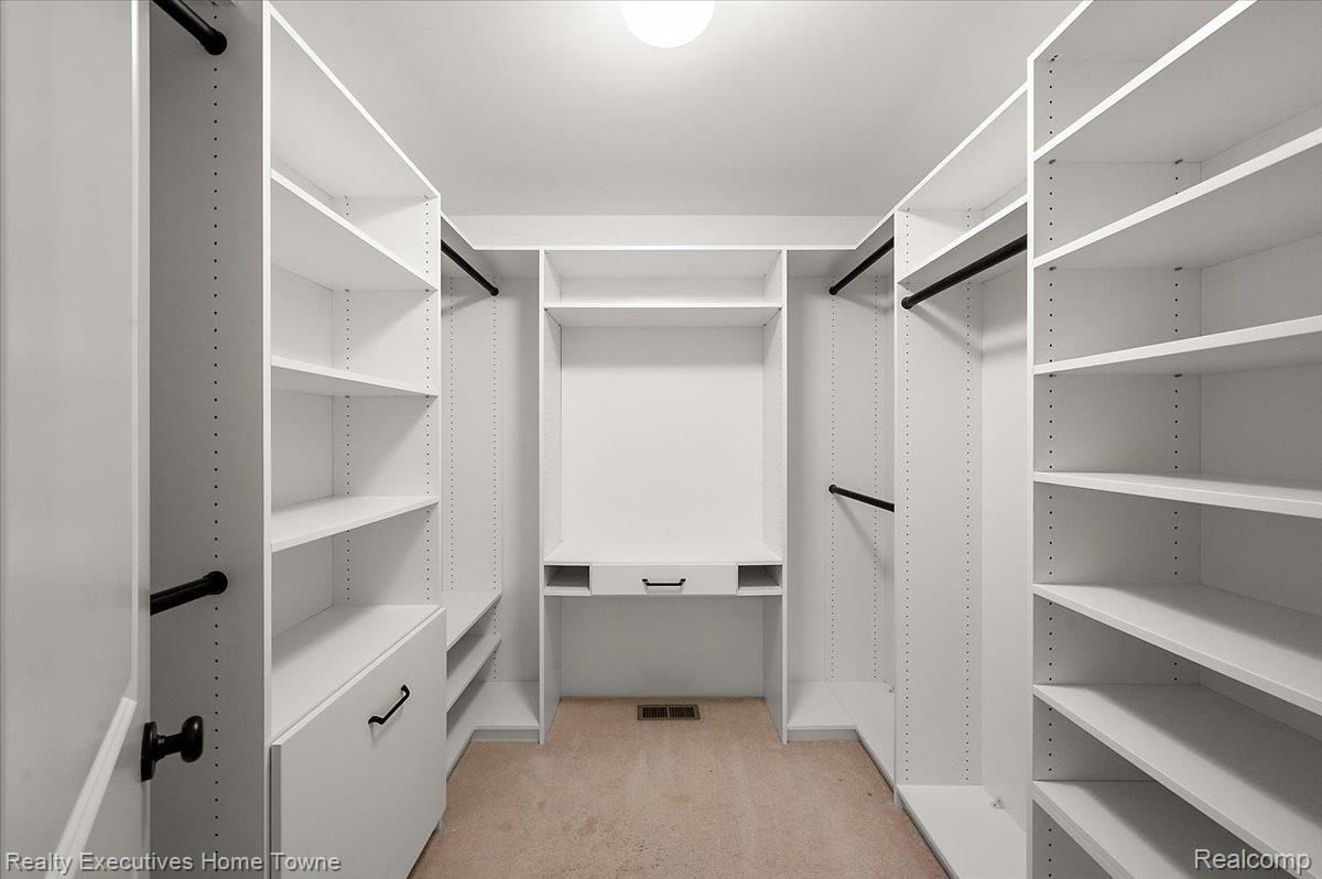 2919 North Addison Circle Rochester, MI 48306 - Photo 41 of 69 Custom closet system featuring multiple shelving units, hanging rods, and built-in drawers