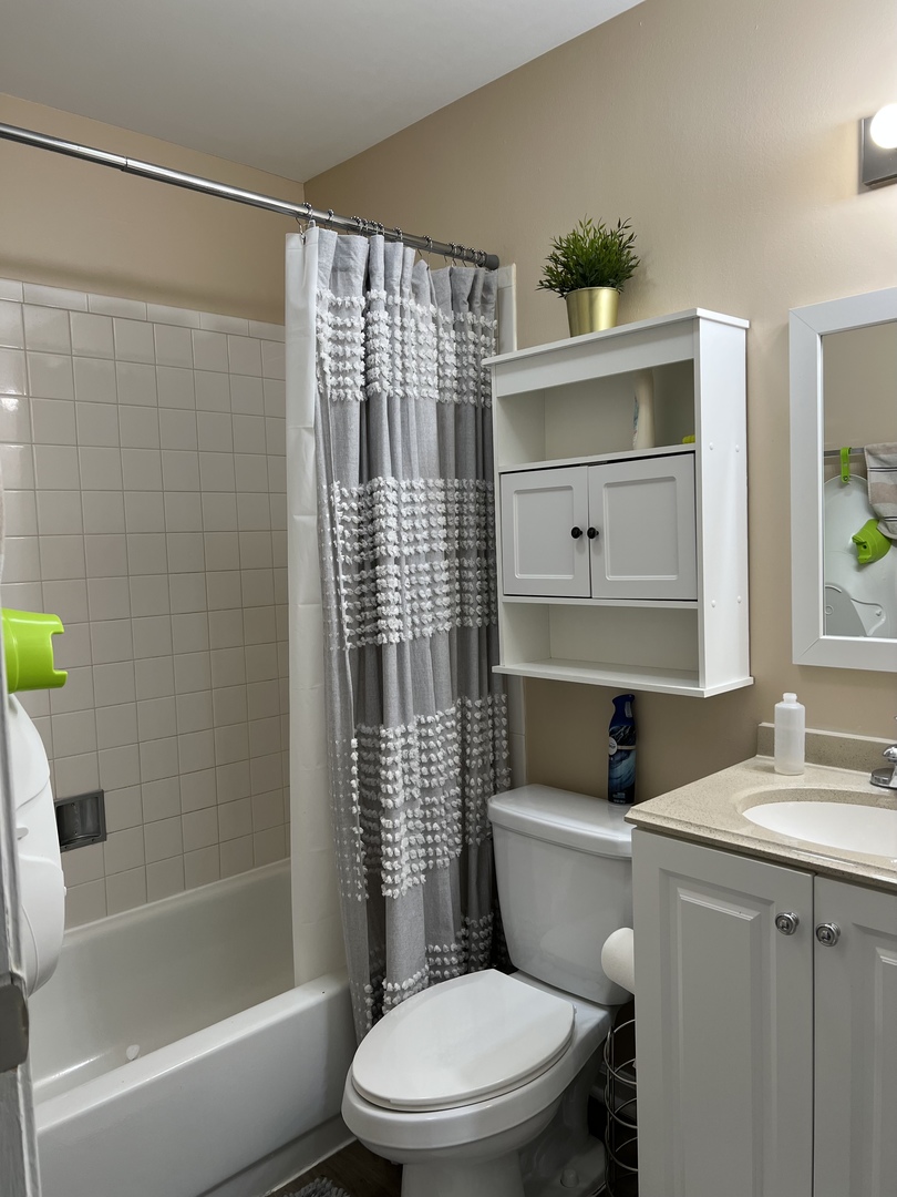 1931 North Hicks Road, Unit 211 Palatine, IL 60074 - Photo 13 of 18 a white toilet sitting next to a bathroom sink