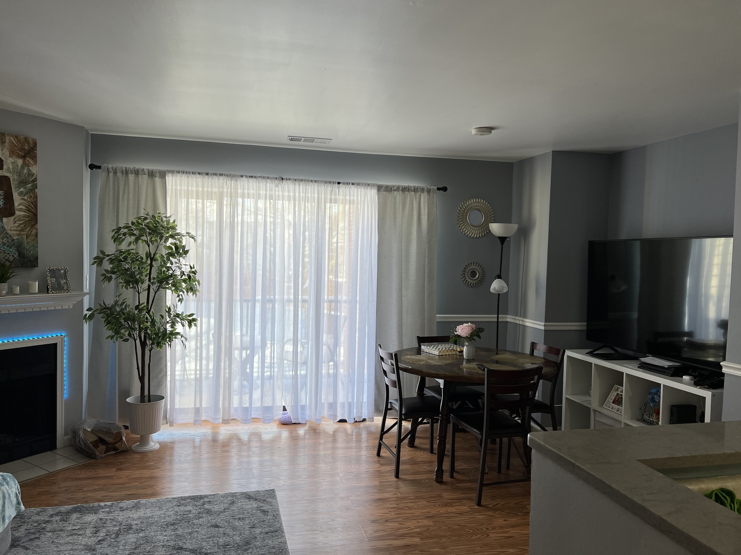1931 North Hicks Road, Unit 211 Palatine, IL 60074 - Photo 6 of 18 a view of a livingroom with furniture and a flat screen tv
