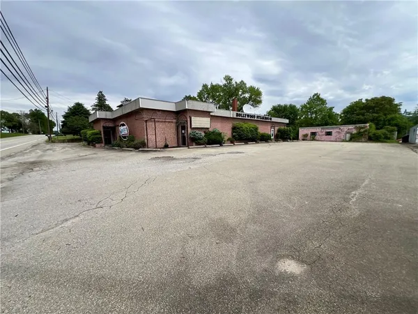 a big house with a big yard and large trees