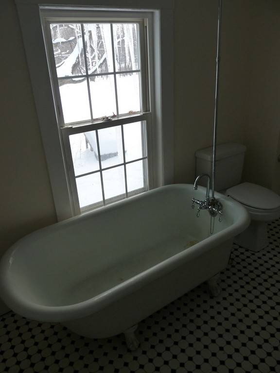 478-480 Gleasondale Road Stow, MA 01775 - Photo 4 of 10 a bath tub sitting next to a window