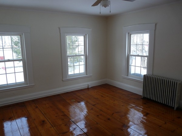 478-480 Gleasondale Road Stow, MA 01775 - Photo 5 of 10 an empty room with wooden floor and windows