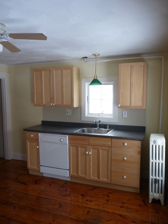 478-480 Gleasondale Road Stow, MA 01775 - Photo 9 of 10 a kitchen with granite countertop a sink cabinets and wooden floor