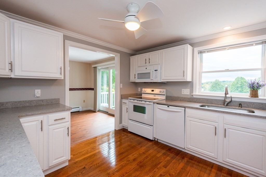 20 Ocean Drive Ipswich, MA 01938 - Photo 15 of 32 a kitchen with granite countertop white cabinets and white appliances