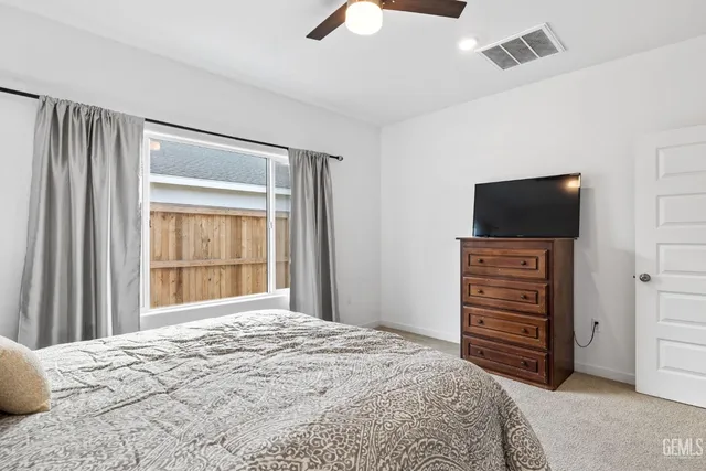 a bedroom with a bed and lamp