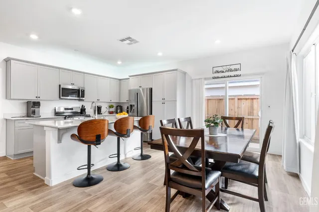 a view of kitchen with cabinets table and chairs