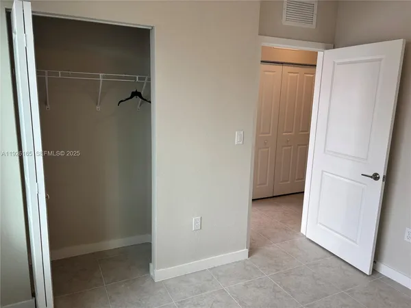 a view of a hallway with windows and stairs