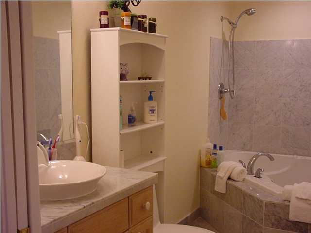 210 Pelham Road, Unit B104 Fort Walton Beach, FL 32547 - Photo 6 of 9 a bathroom with a sink and mirror