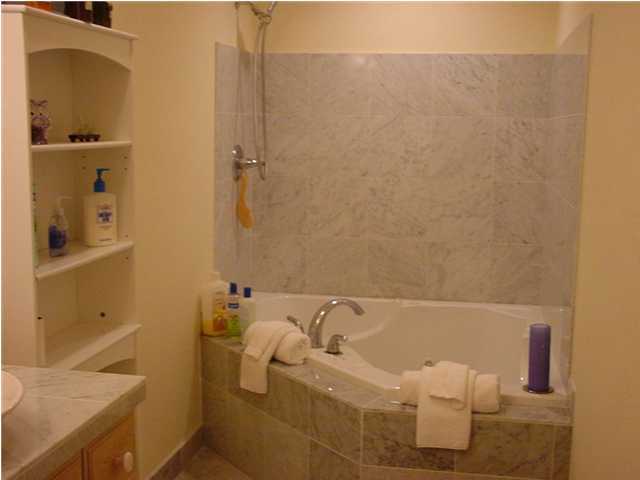 210 Pelham Road, Unit B104 Fort Walton Beach, FL 32547 - Photo 7 of 9 a bathroom with a bathtub and sink
