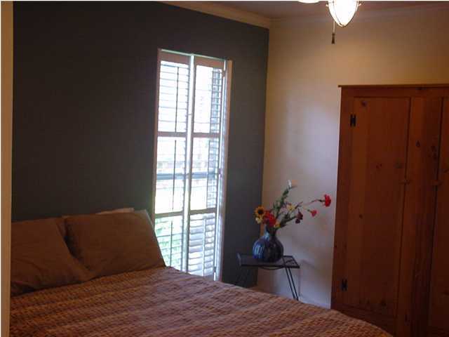 210 Pelham Road, Unit B104 Fort Walton Beach, FL 32547 - Photo 8 of 9 a bedroom with a bed and a window