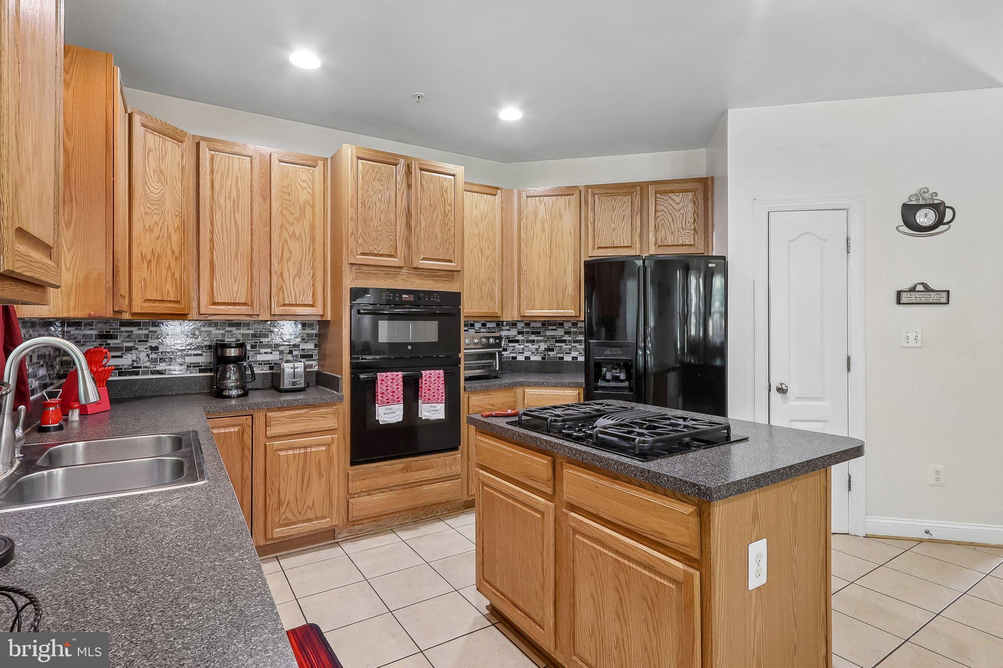 9003 Eldon Drive Clinton, MD 20735 - Photo 11 of 54 Modern kitchen with warm wood tones.