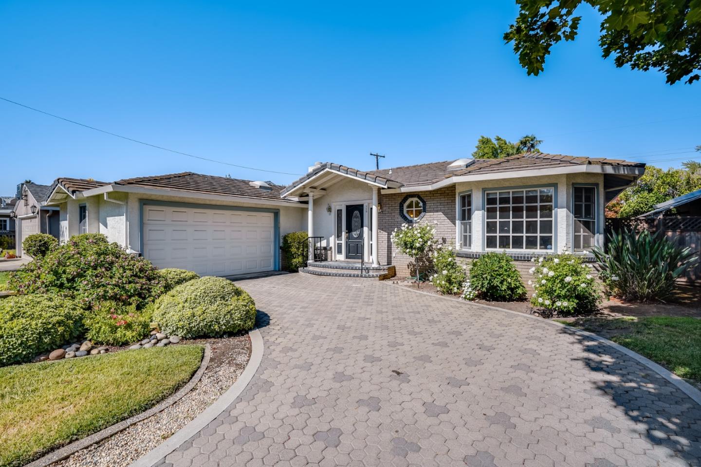 a front view of a house with a garden