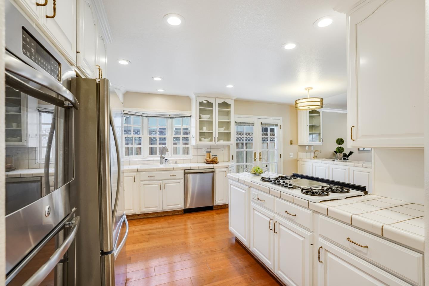 715 Pineview Drive San Jose, CA 95050 - Photo 8 of 34 a kitchen with stainless steel appliances kitchen island granite countertop a stove and a refrigerator