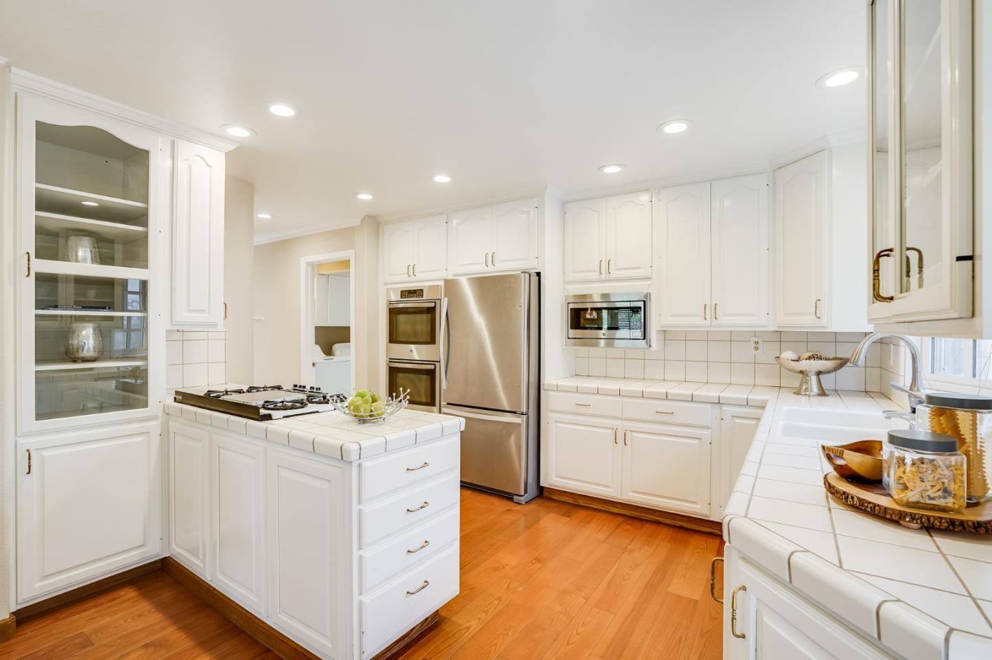 715 Pineview Drive San Jose, CA 95050 - Photo 9 of 34 a kitchen with stainless steel appliances kitchen island granite countertop a stove and a sink