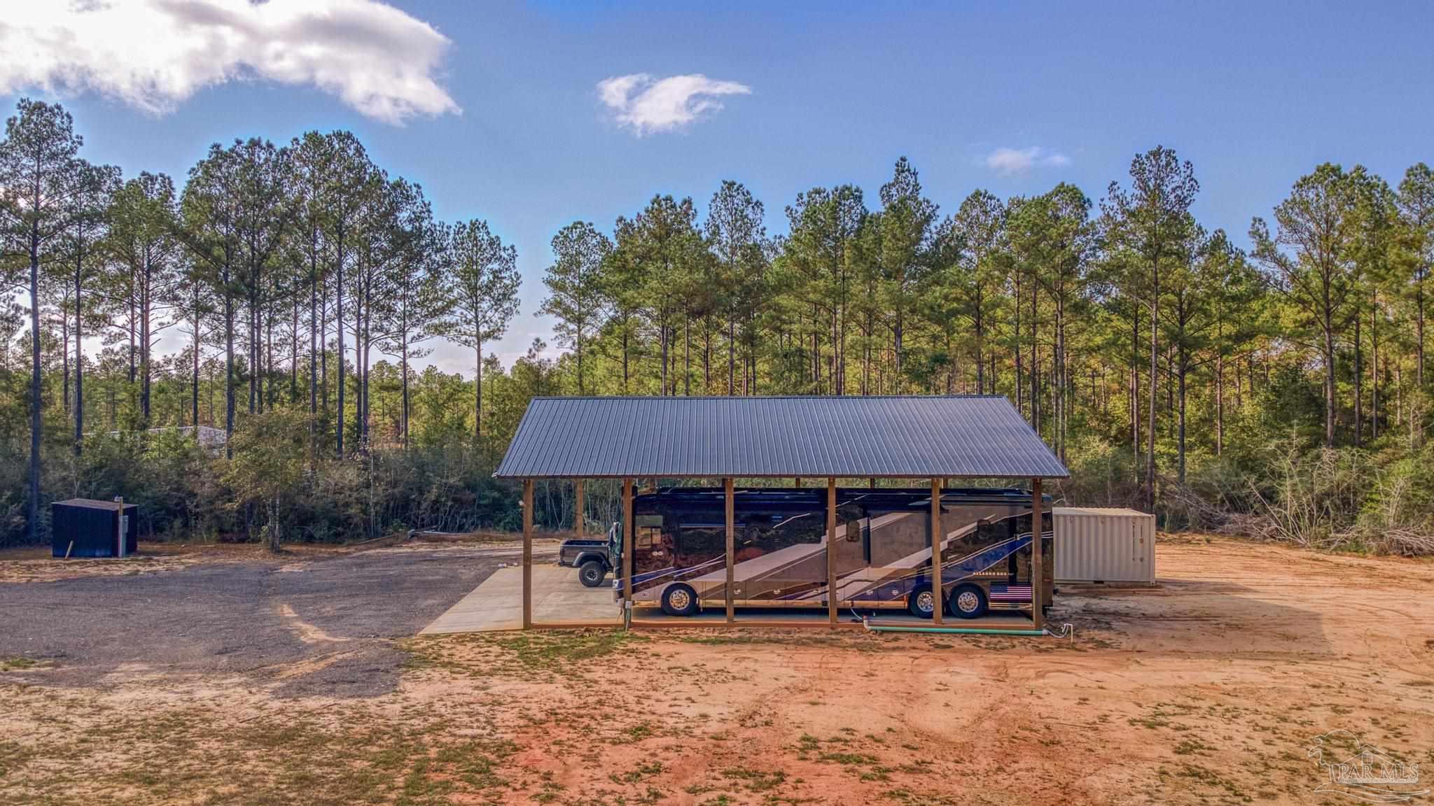 8030 Gin Road Milton, FL 32571 - Photo 12 of 13 a view of a house with backyard space and sitting area