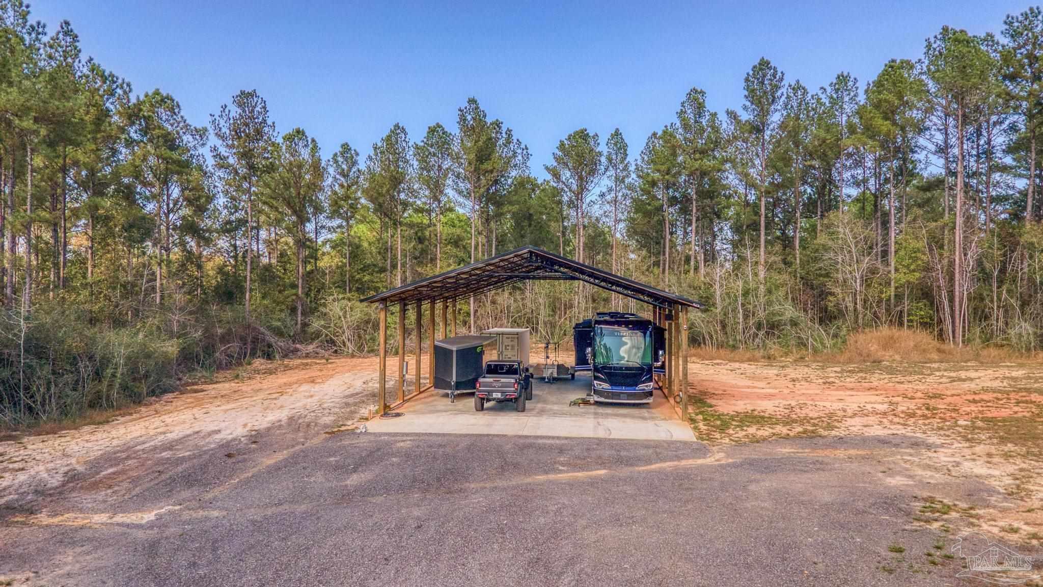 8030 Gin Road Milton, FL 32571 - Photo 13 of 13 a view of a patio with a table and chairs under an umbrella
