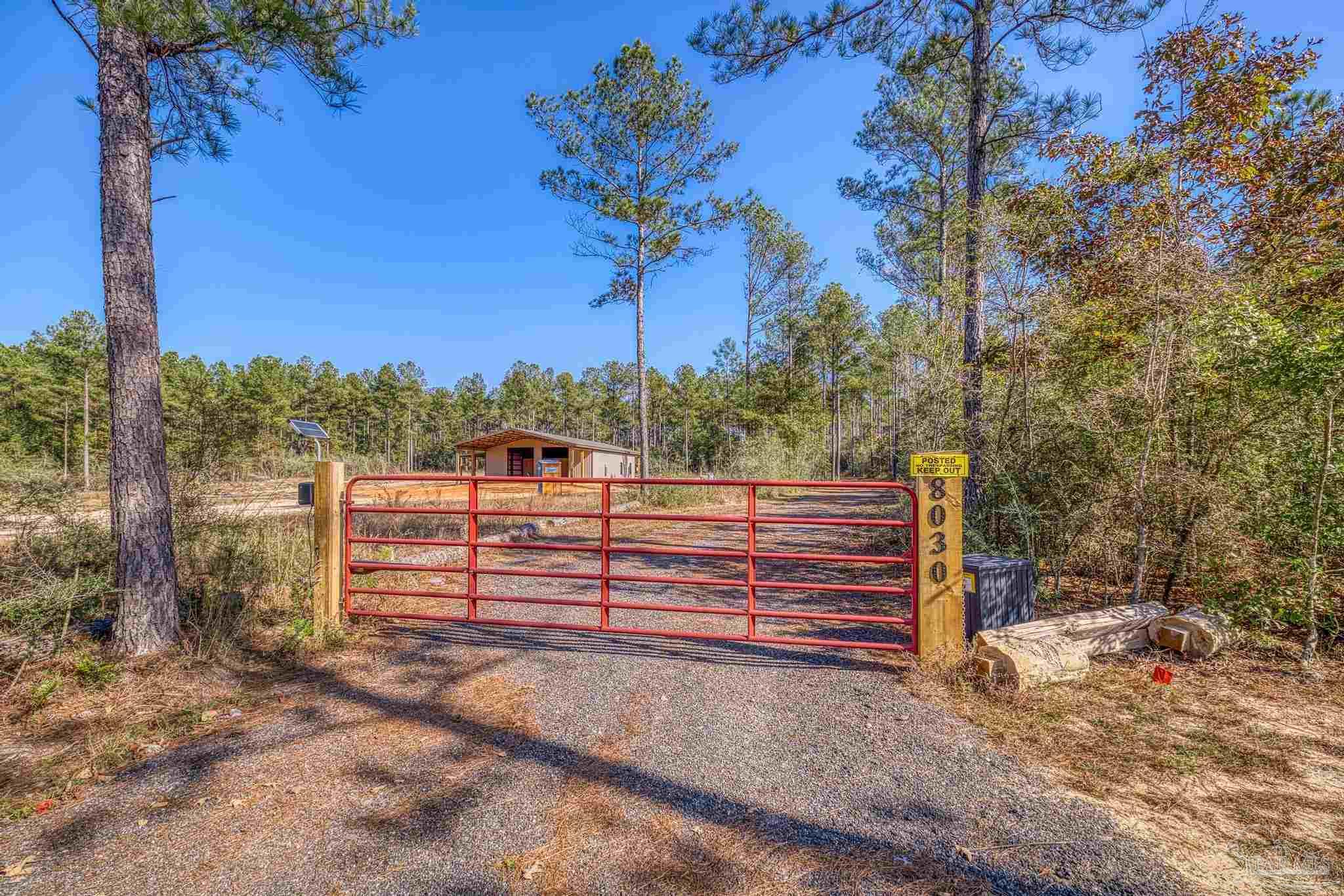 8030 Gin Road Milton, FL 32571 - Photo 9 of 13 a view of a bench in a yard