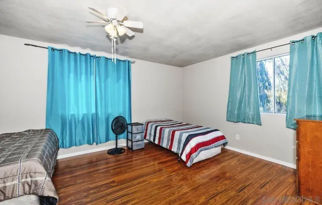 a living room with a bed furniture and a window