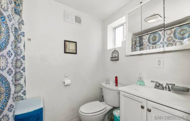 a white toilet sitting next to a bathroom sink
