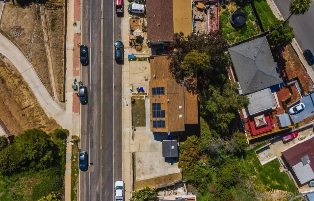 an aerial view of residential house with parking