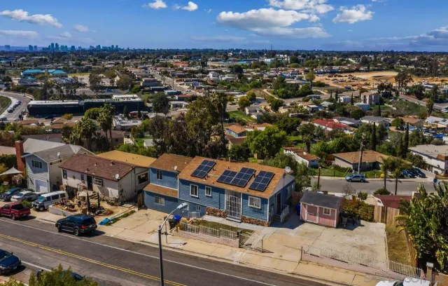 an aerial view of residential houses with outdoor space