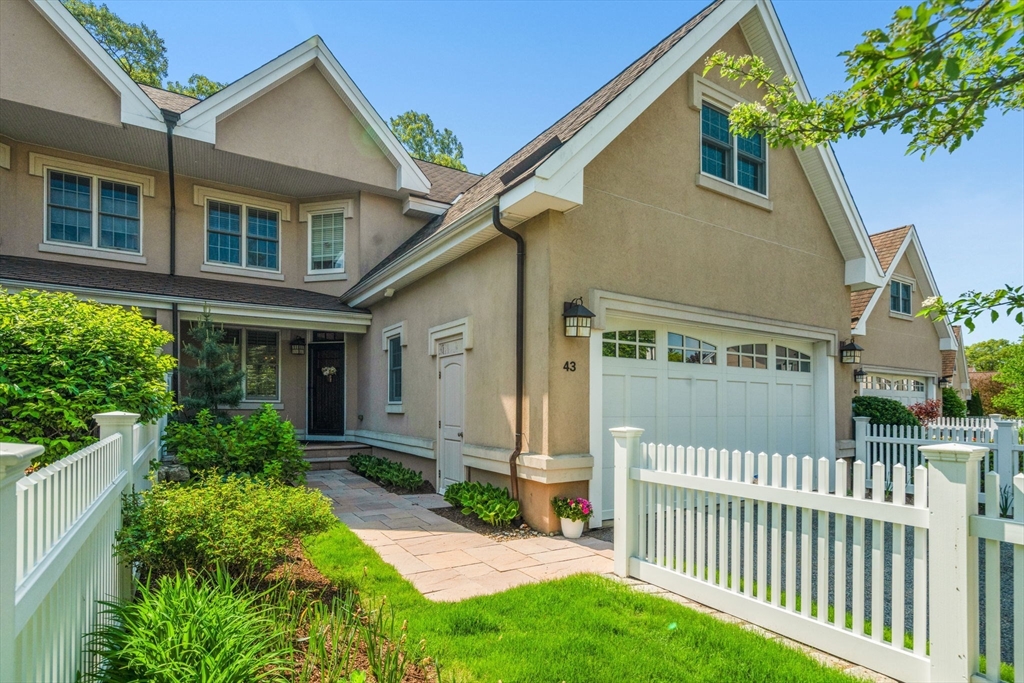 287 Langley Road, Unit 43 Newton, MA 02459 - Photo 1 of 36 front view of a house with a yard
