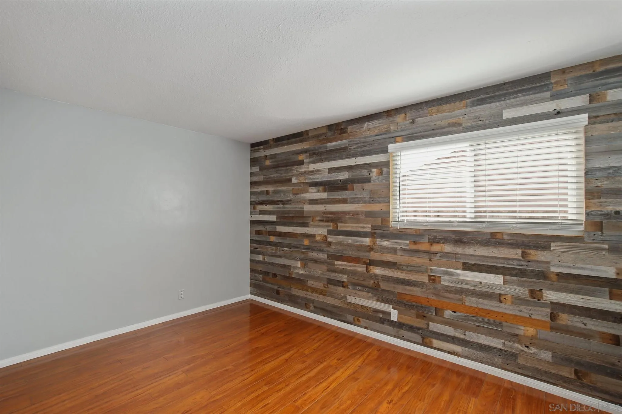 13432 Carriage Road Poway, CA 92064 - Photo 15 of 27 a view of empty room with wooden floor and fan