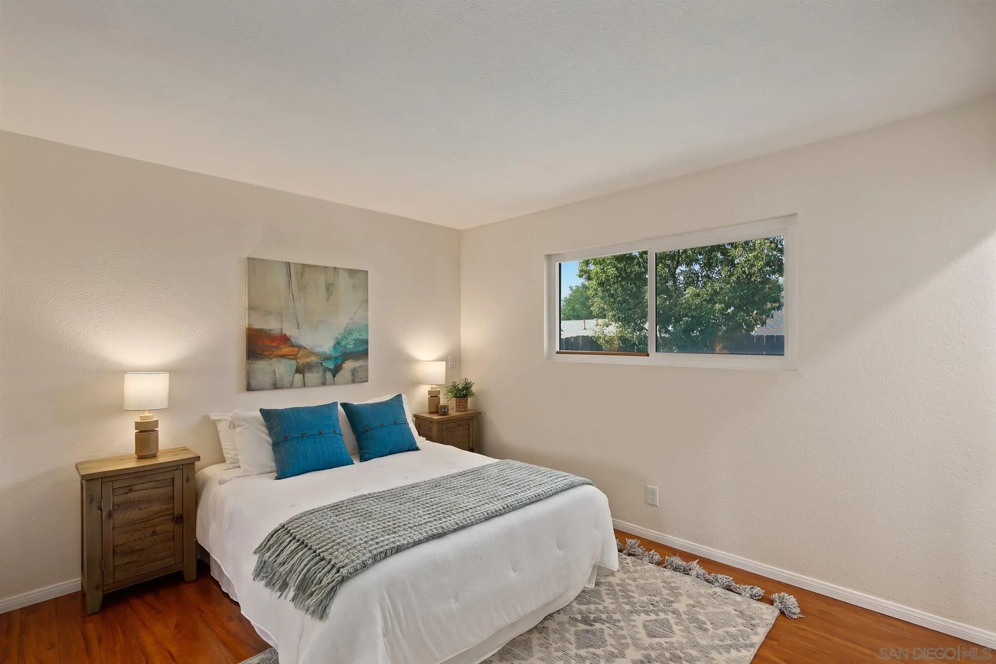 13432 Carriage Road Poway, CA 92064 - Photo 17 of 27 a bedroom with a bed and wooden floor