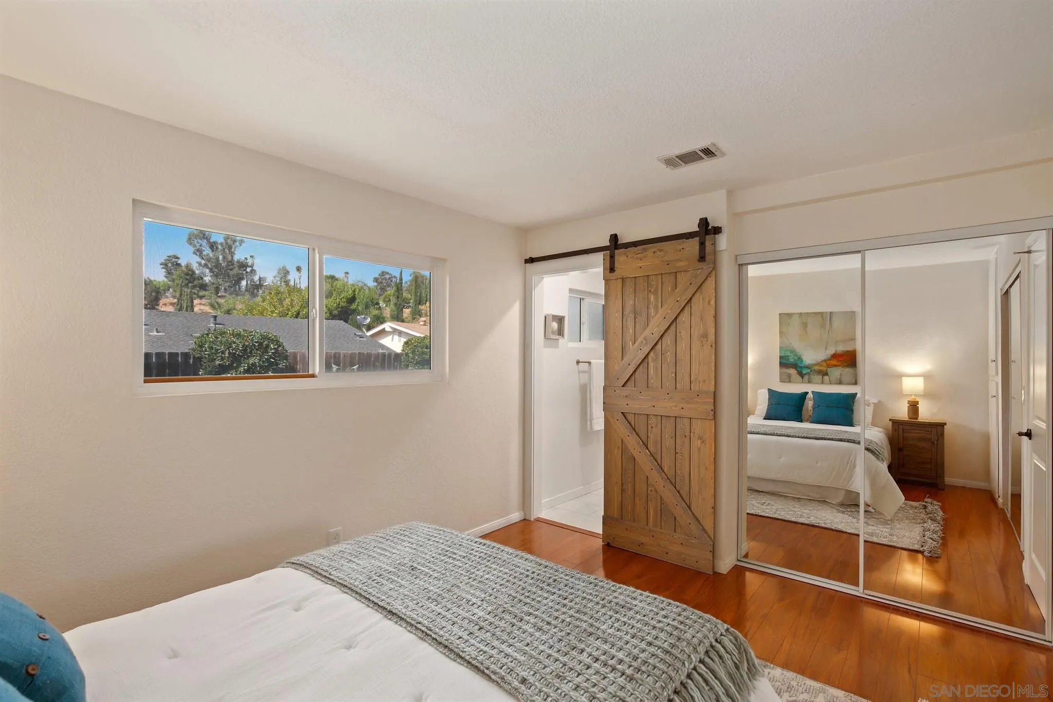 13432 Carriage Road Poway, CA 92064 - Photo 18 of 27 a bedroom with a bed and a view of bathroom