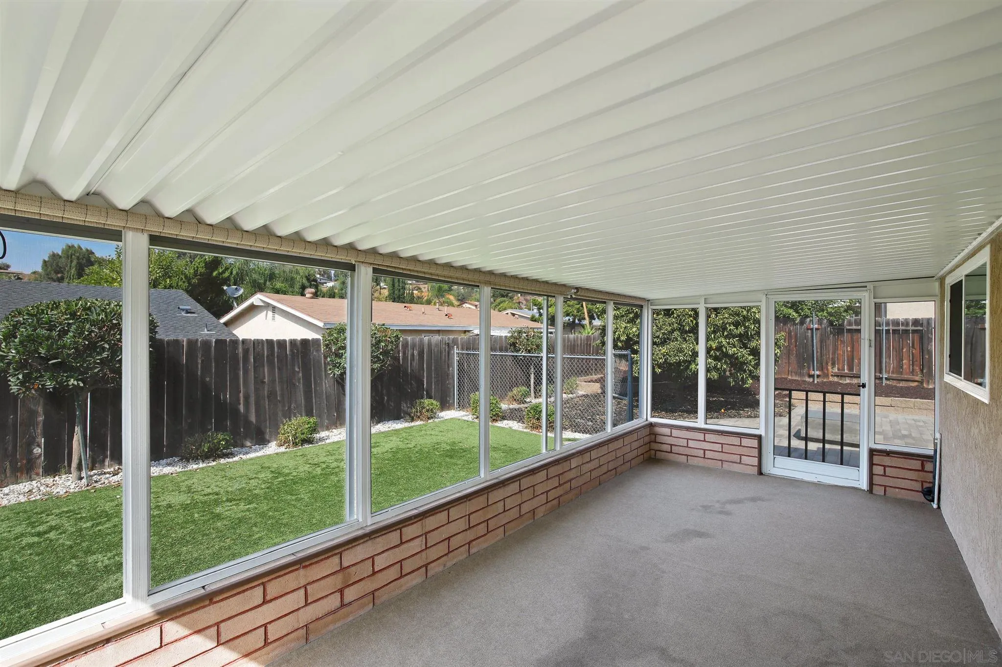 13432 Carriage Road Poway, CA 92064 - Photo 21 of 27 a view of a house with a floor to ceiling windows and wooden fence