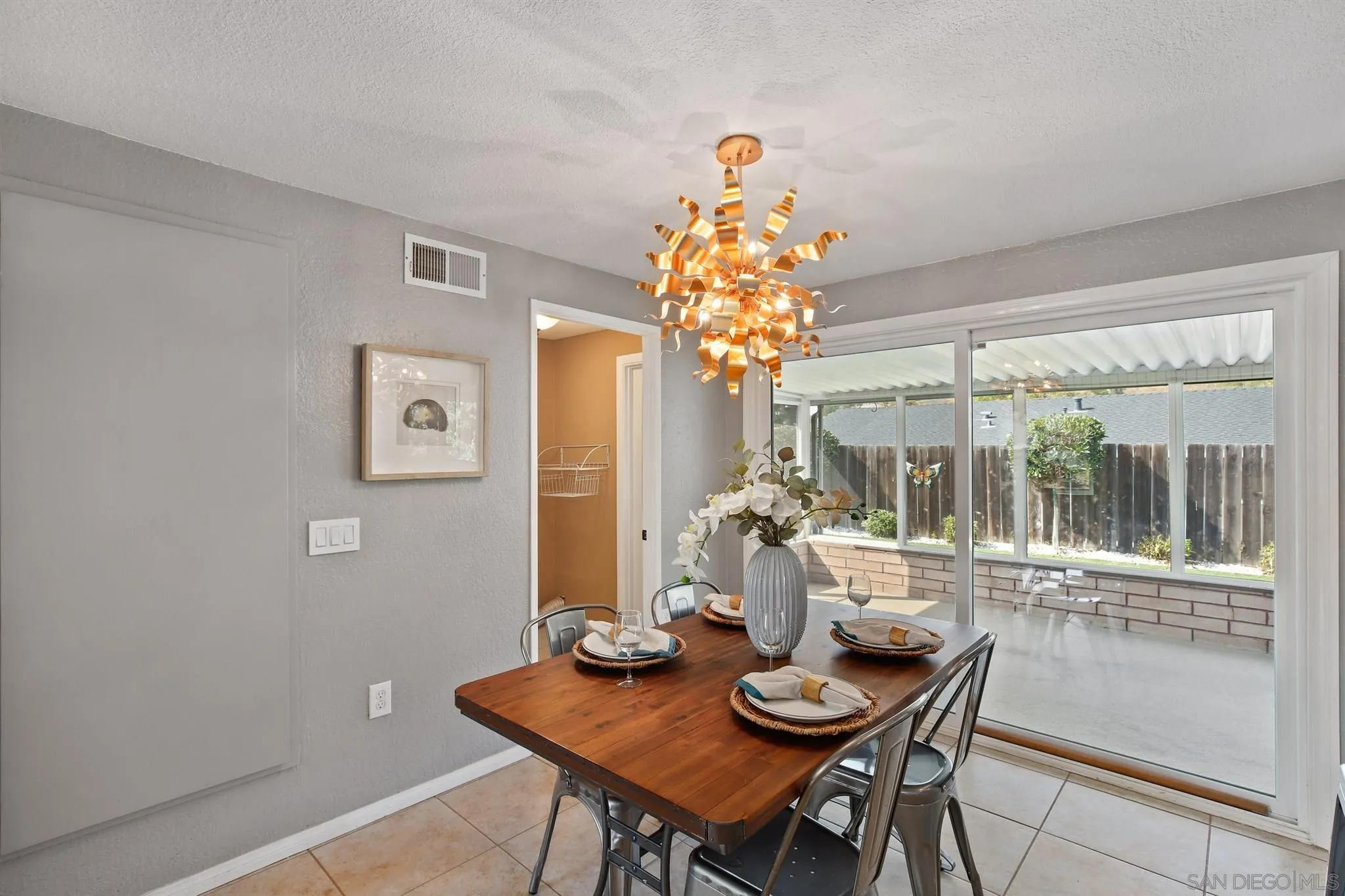 13432 Carriage Road Poway, CA 92064 - Photo 8 of 27 a view of a dining room with furniture a chandelier and large windows