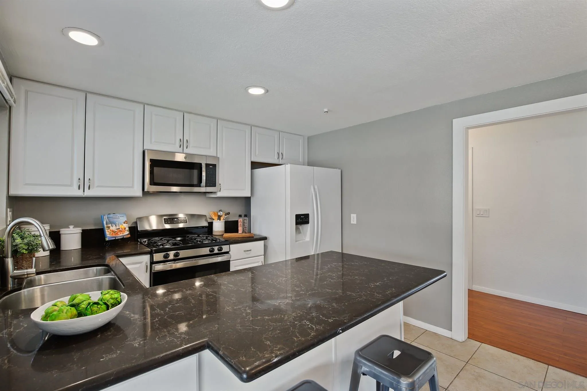 13432 Carriage Road Poway, CA 92064 - Photo 10 of 27 a kitchen with stainless steel appliances granite countertop a refrigerator a stove a microwave a sink and cabinets