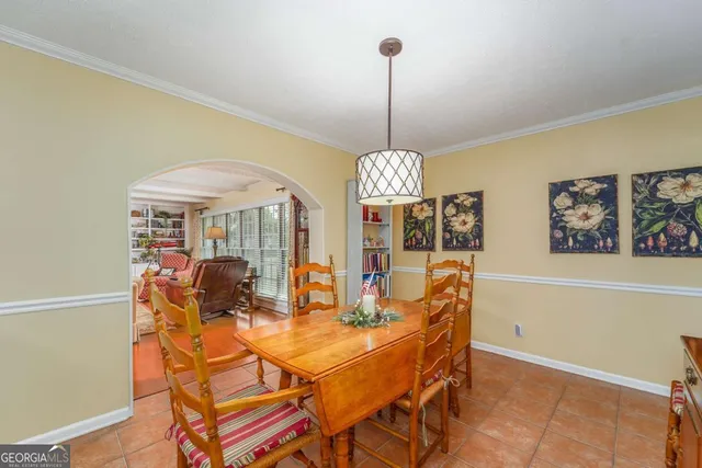 a view of a dining room with furniture wooden floor and chandelier