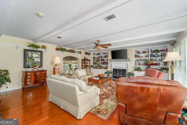 a living room with fireplace furniture and a flat screen tv