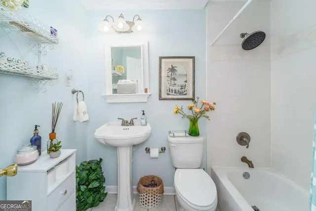 a bathroom with a sink mirror and toilet