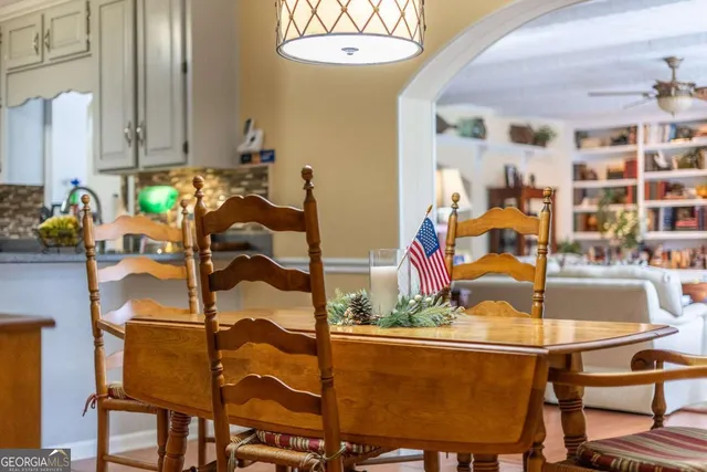 a view of a dining room with furniture and chandelier