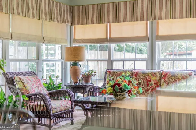 a living room filled with furniture and a large window