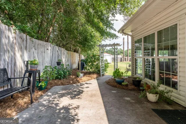 a view of a backyard with sitting area and garden