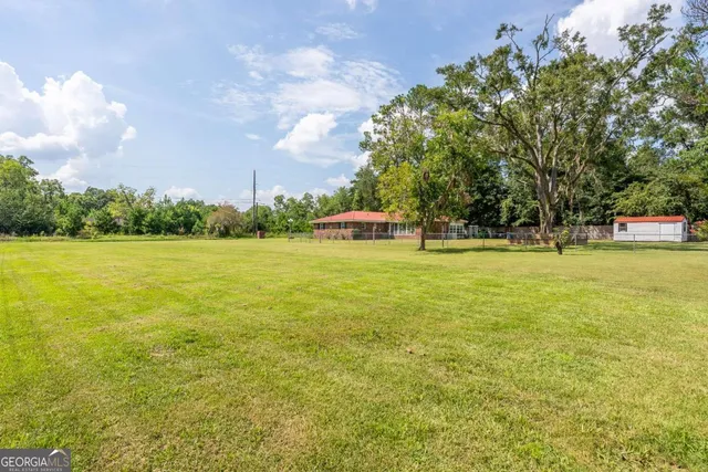 a view of a green yard with a house