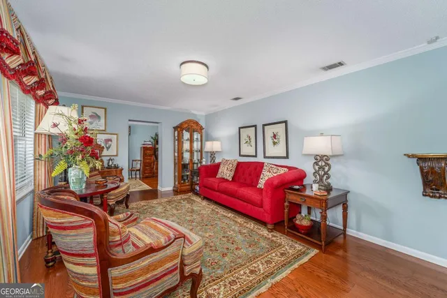 a living room with furniture a couch and a potted plant