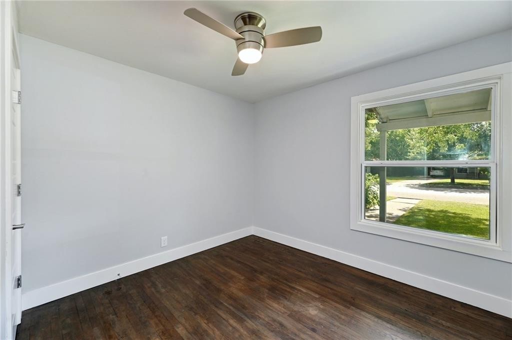 8318 Burrell Drive Austin, TX 78757 - Photo 18 of 27 Empty room featuring dark wood finished floors and ceiling fan